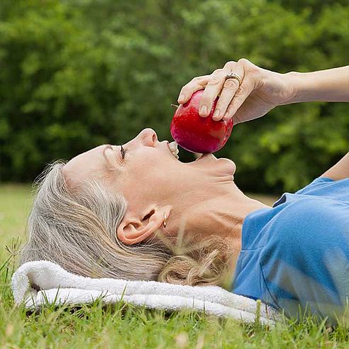 Woman bites into apple | Protefix